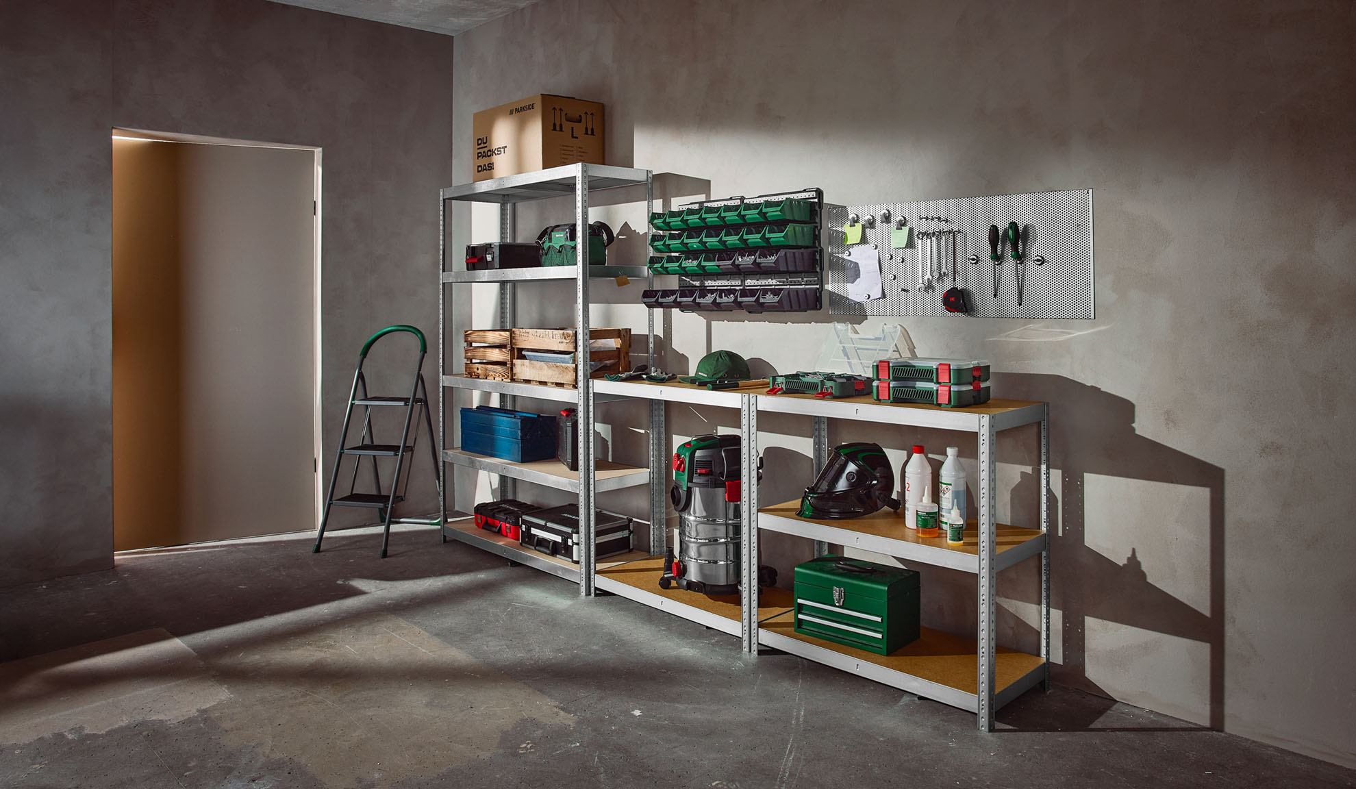 A well-organized garage or workshop with metal shelving units, storage bins, tools, and a step ladder.