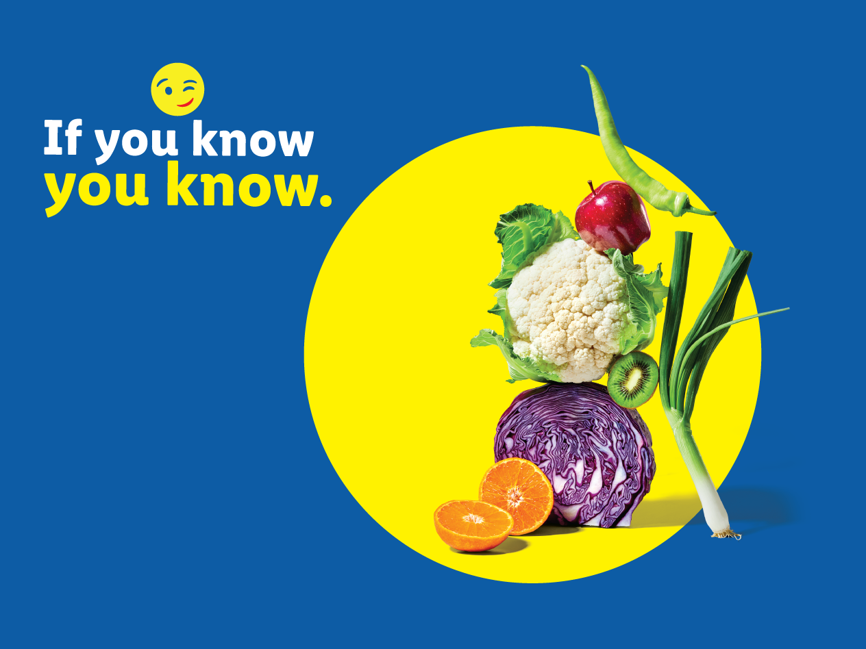 Fresh produce including cauliflower, red cabbage, oranges, apple, kiwi, and spring onion with text: If you know, you know.