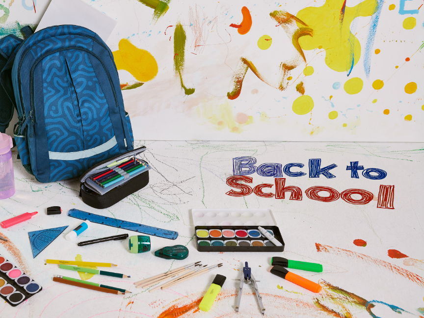 Backpack, school supplies, and paints on a white surface with 'Back to School' text.