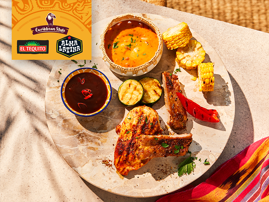 Grilled Caribbean-style meal with meat, vegetables, and sauces, featuring El Tequito and Alma Latina.