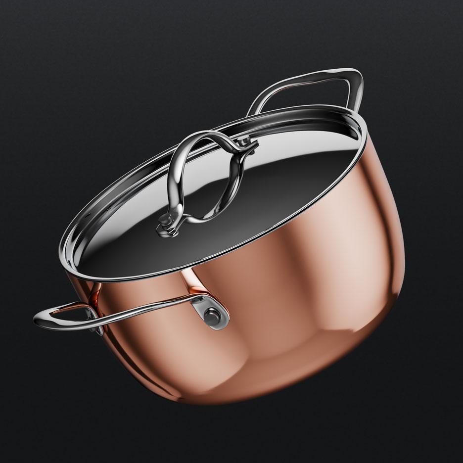 Copper pot with lid and stainless steel handles.