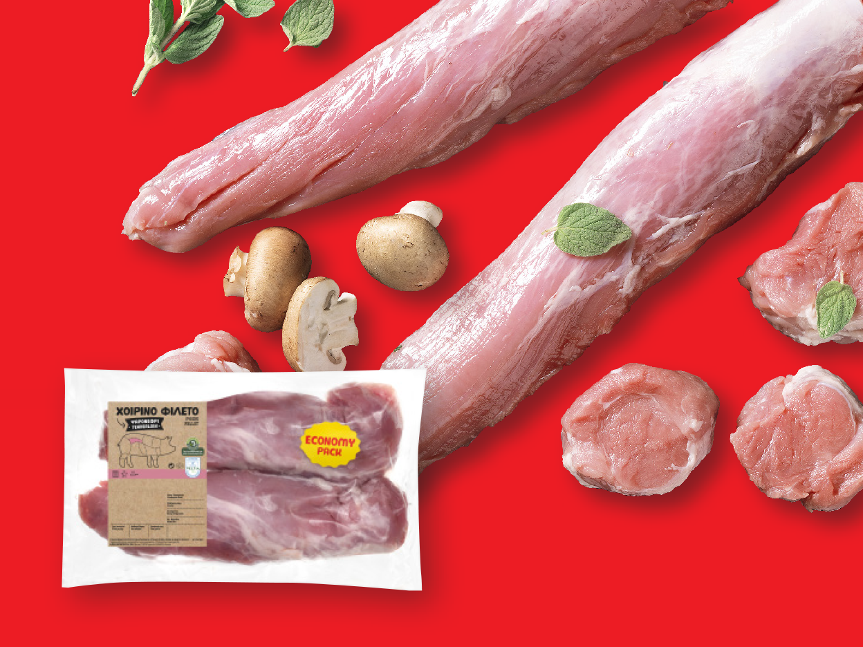 Pork tenderloin and cutlets with mushrooms and herbs on a red background