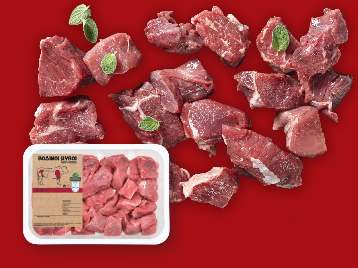 Beef cubes scattered on a red background, with a packaged tray of beef cubes.