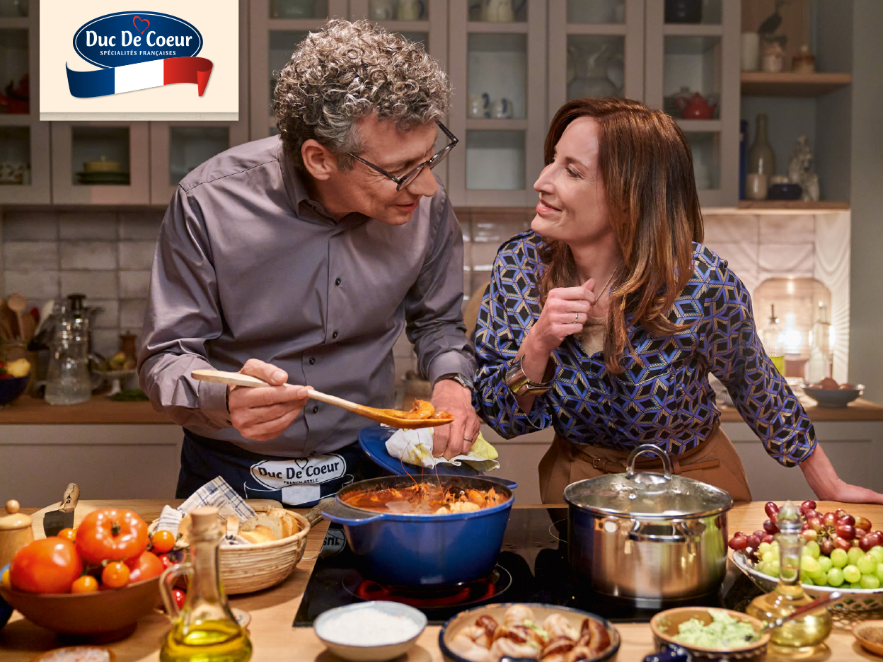 A couple cooks together in the kitchen using Duc De Coeur products.