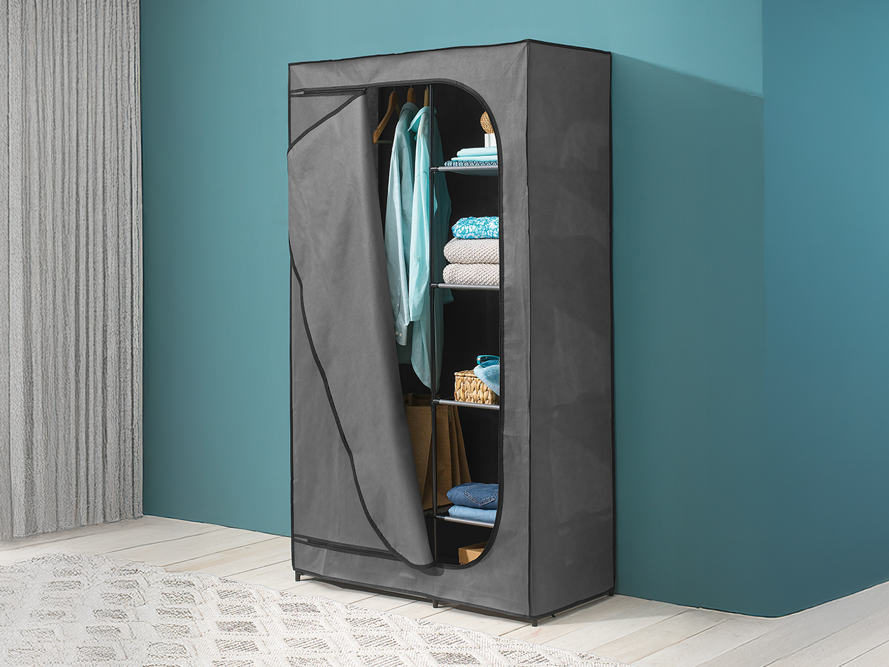 A gray fabric wardrobe with a hanging rail and shelves, filled with clothes.