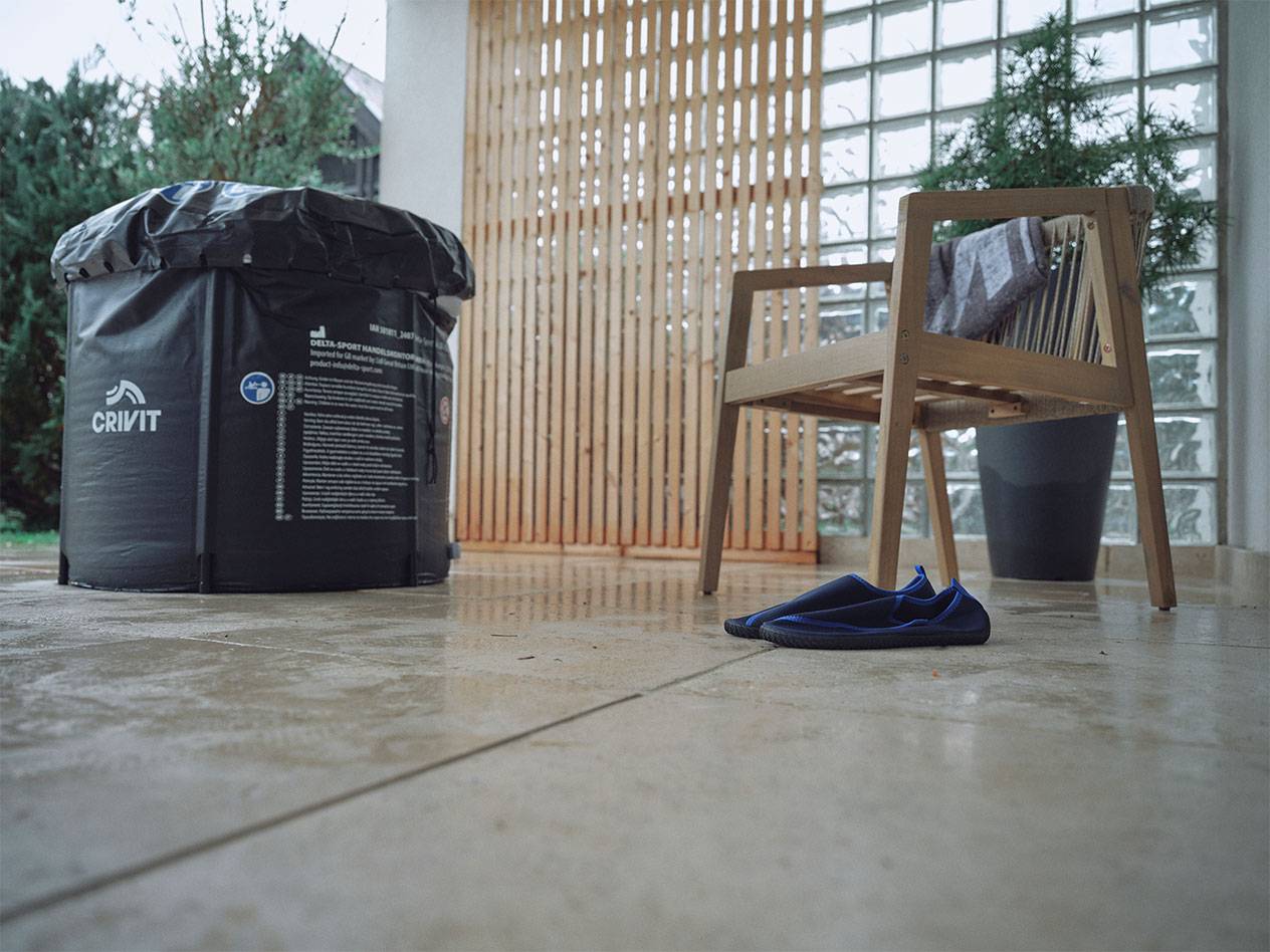 Crivit inflatable pool and water shoes on a patio.