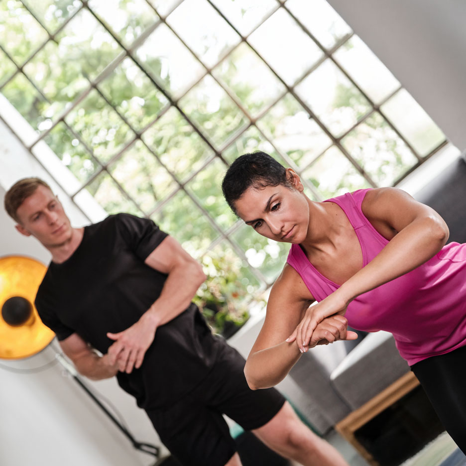 Woman exercising with a personal trainer.