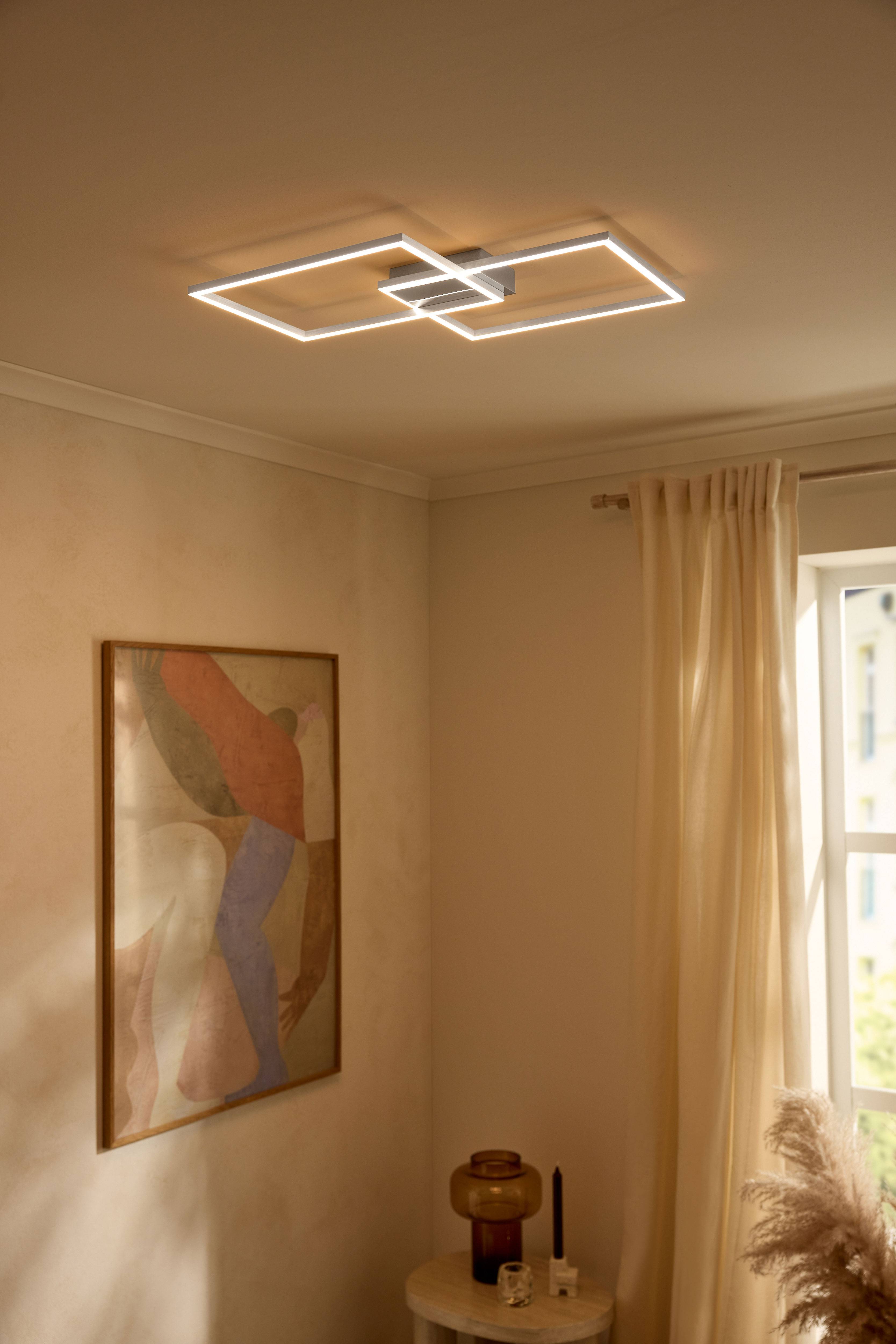 Modern LED ceiling light in rectangular shapes illuminating a beige room.