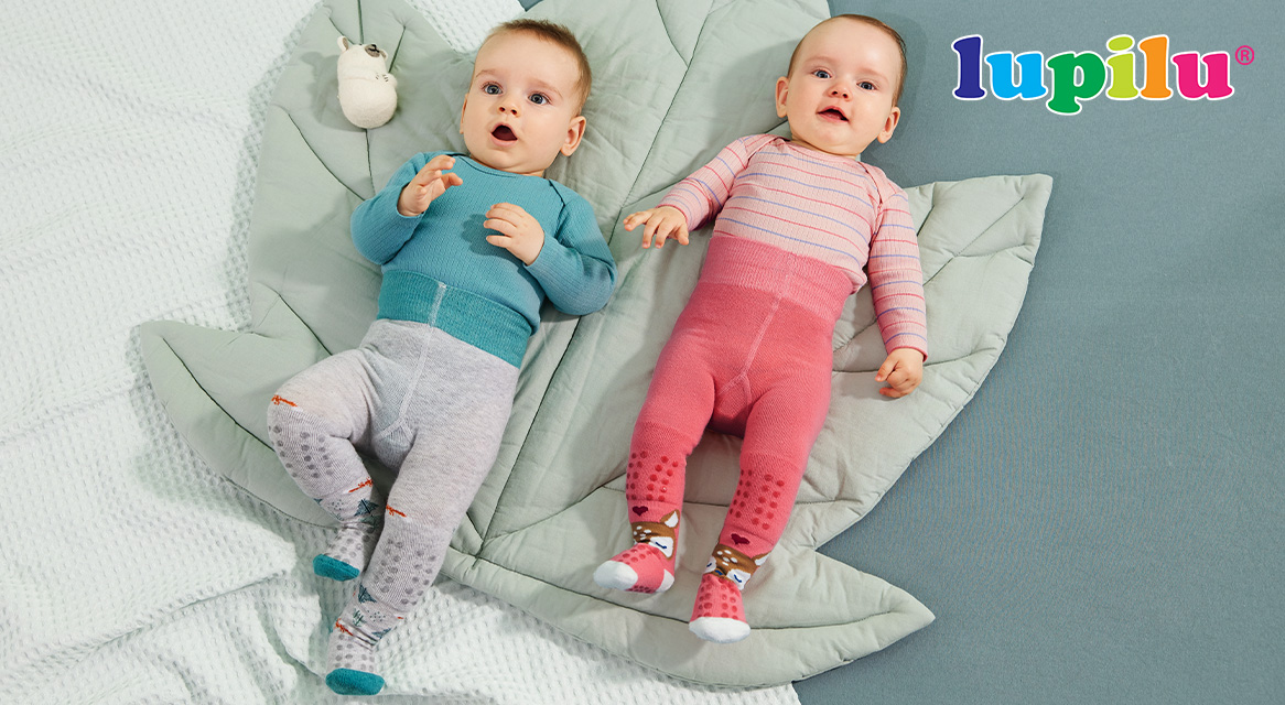 Lupilu baby clothes: bodysuits and leggings on a soft mat.