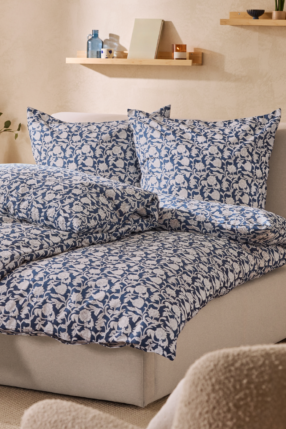 Blue and white floral patterned duvet cover set on a bed in a cozy bedroom.