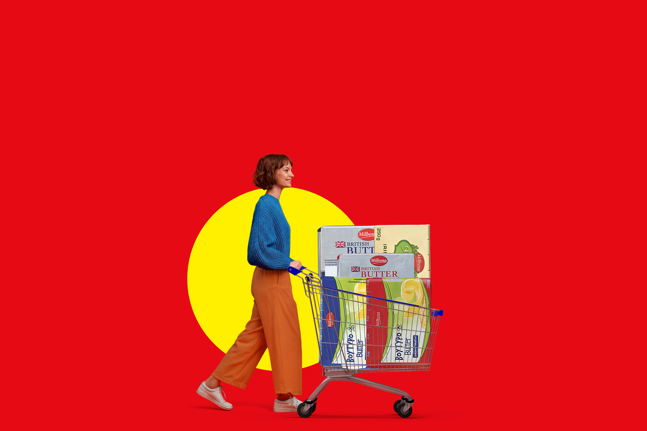 Woman pushing a shopping cart full of butter on a red and yellow background.
