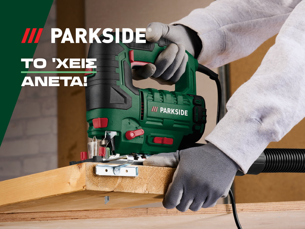 Man using a green Parkside jigsaw to cut wood.