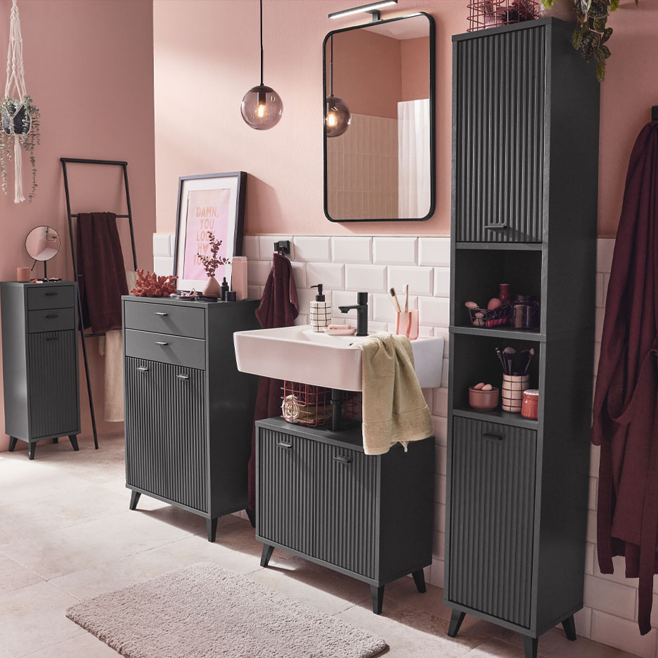 Modern bathroom with dark gray furniture and pink accents.