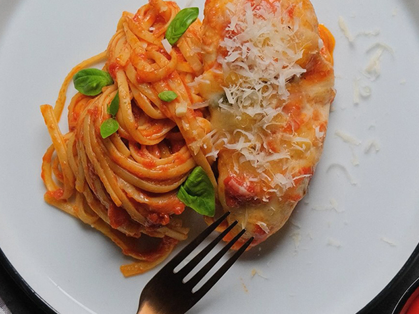 Pasta with tomato sauce and parmesan-crusted chicken.