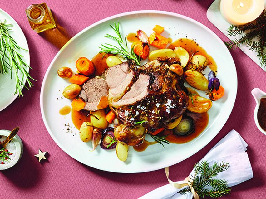 Roast lamb with roasted vegetables and rosemary.