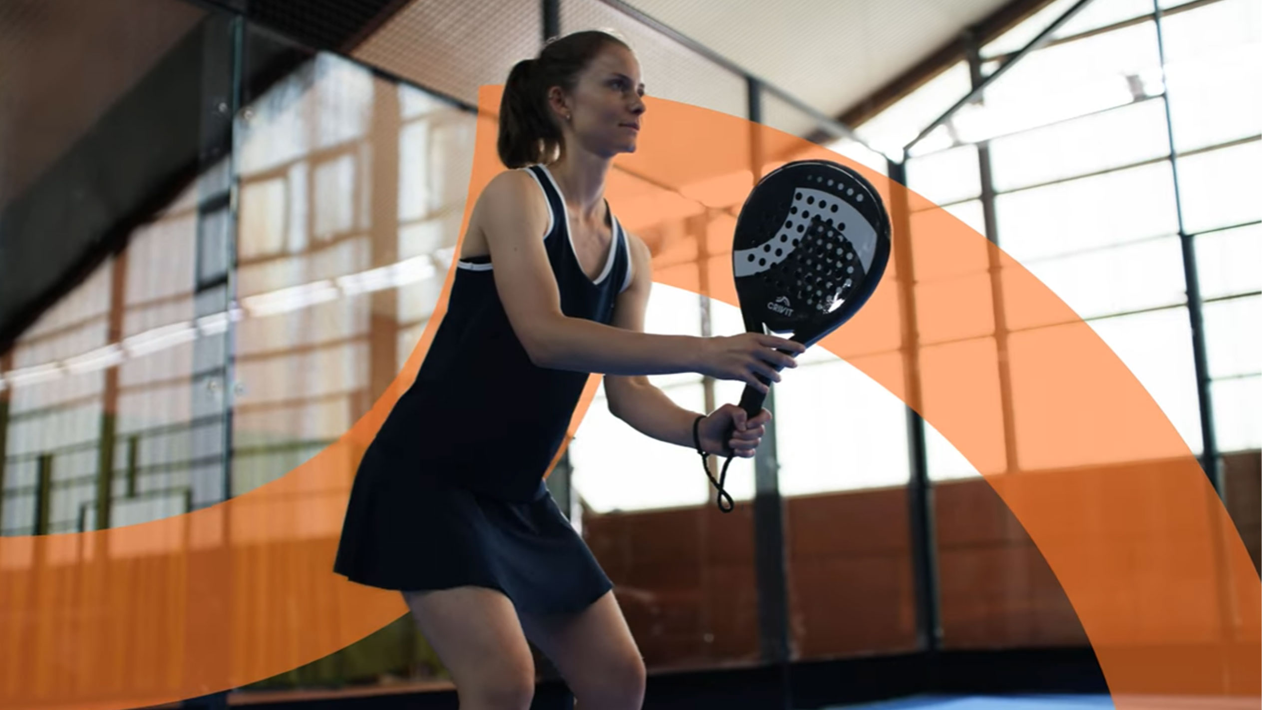 Woman playing padel with Crivit padel racket.