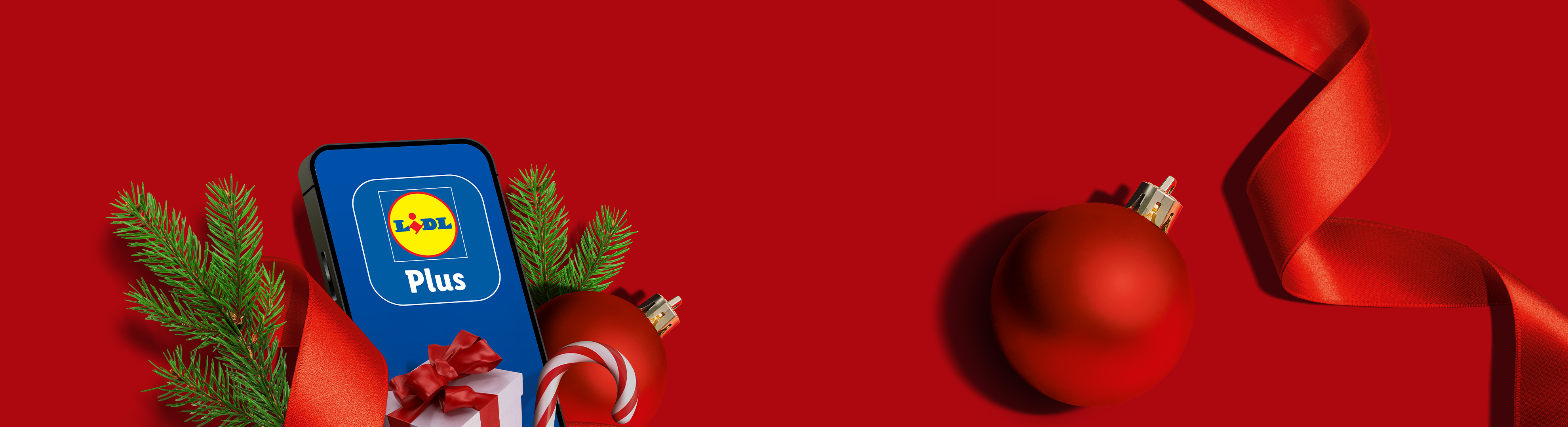 Lidl Plus app on a phone with Christmas decorations on a red background.