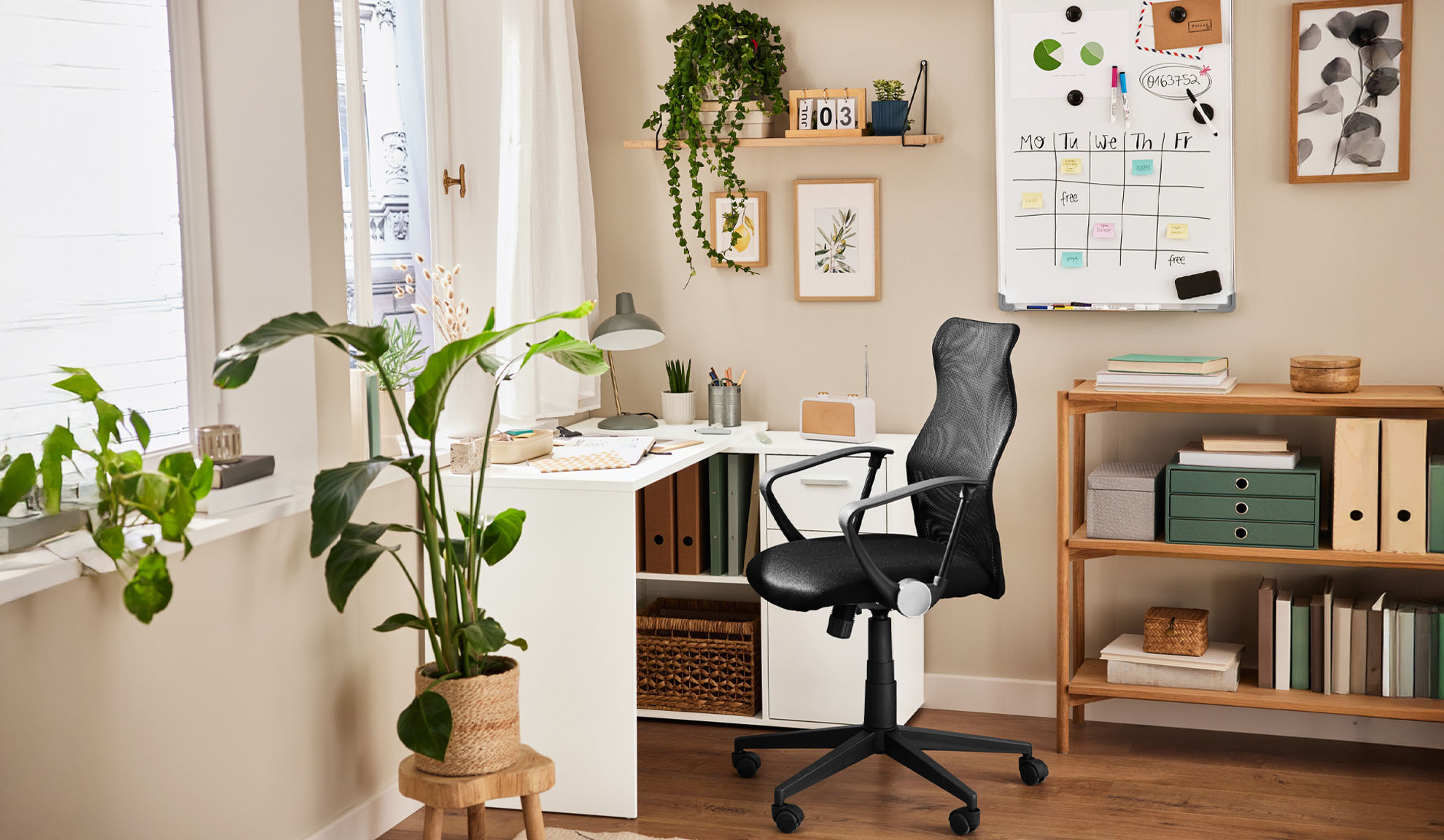 Home office with a corner desk, office chair, and wooden shelving unit.