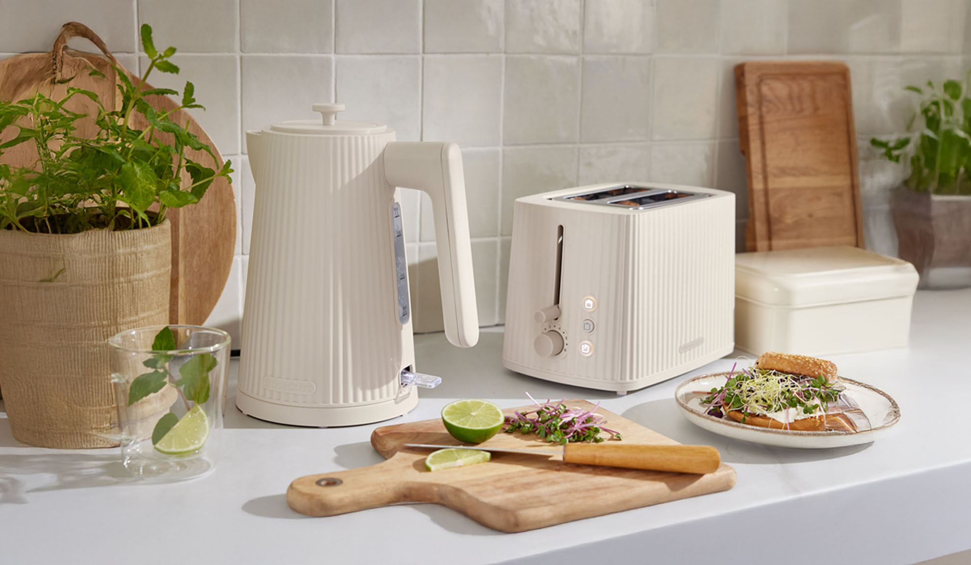 Cream ribbed kettle and toaster on a kitchen counter.