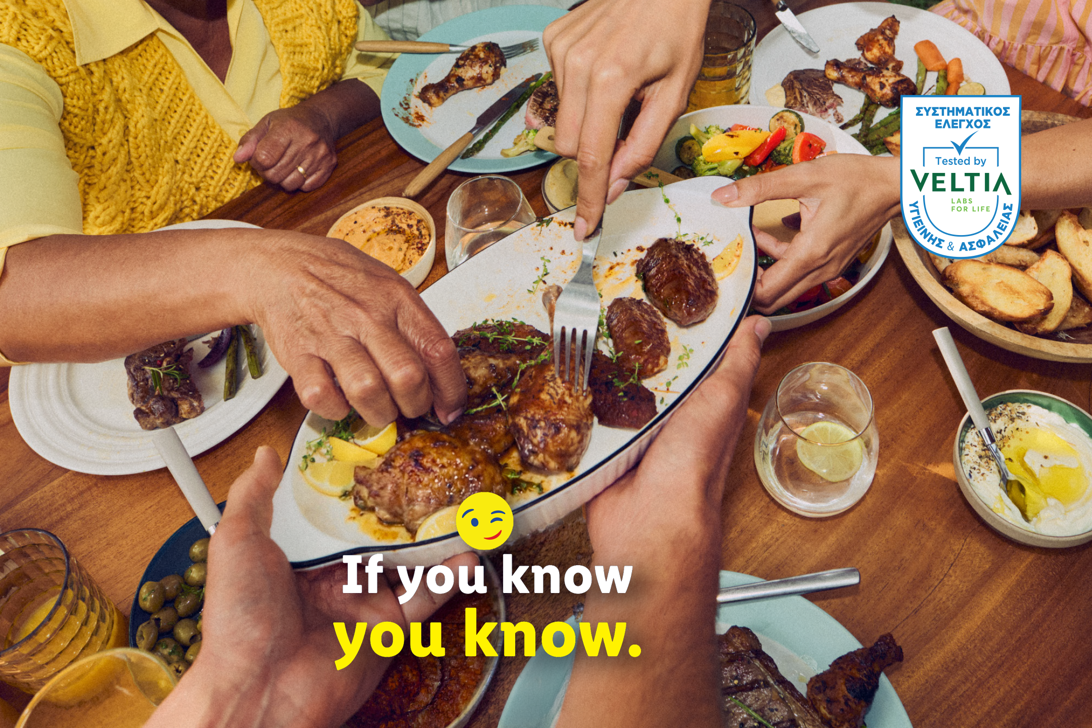 People sharing a meal with grilled meats, vegetables, and dips. Text: 'If you know, you know.'