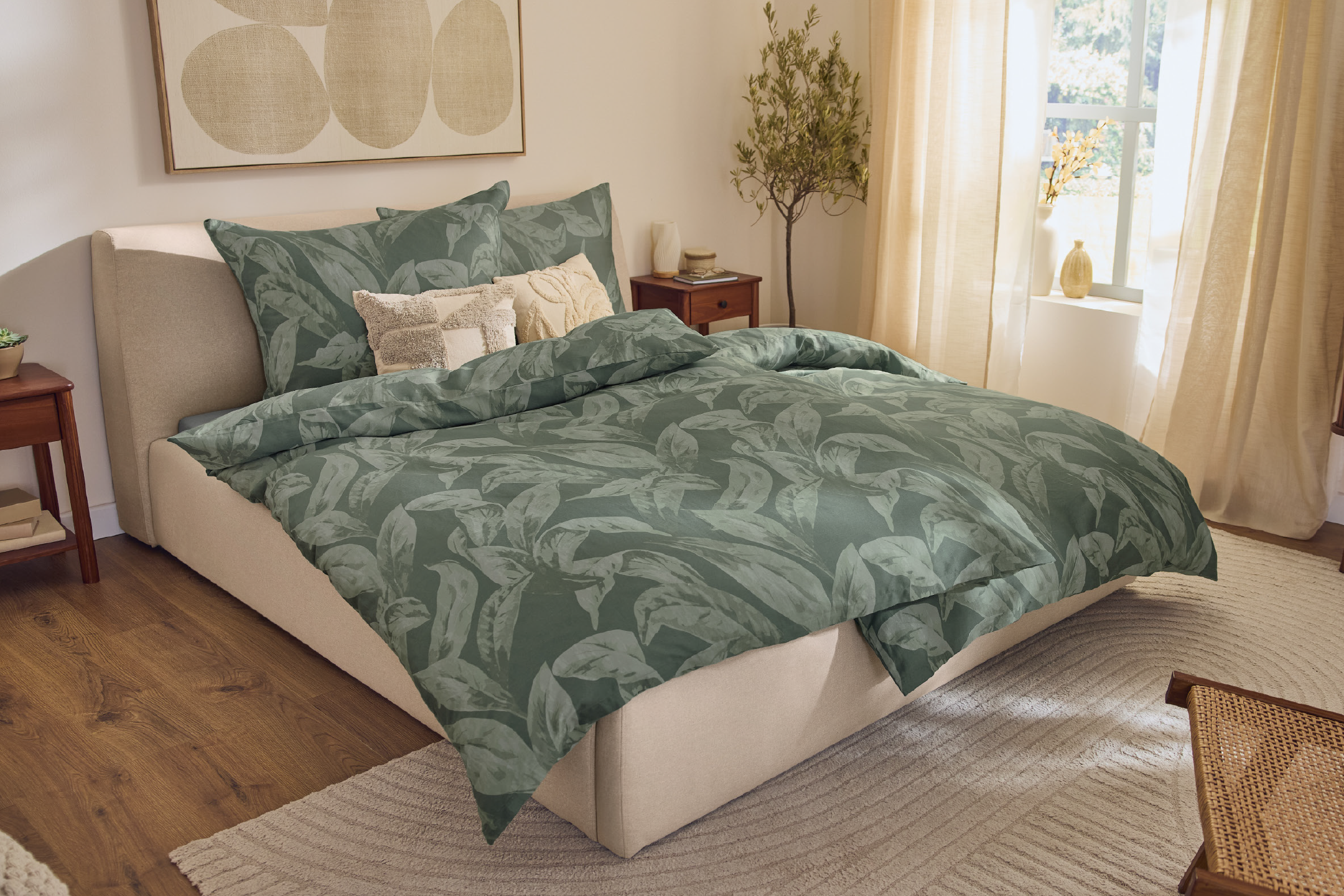 Bedroom with green leaf-patterned duvet cover, beige bed, and light-colored rug.