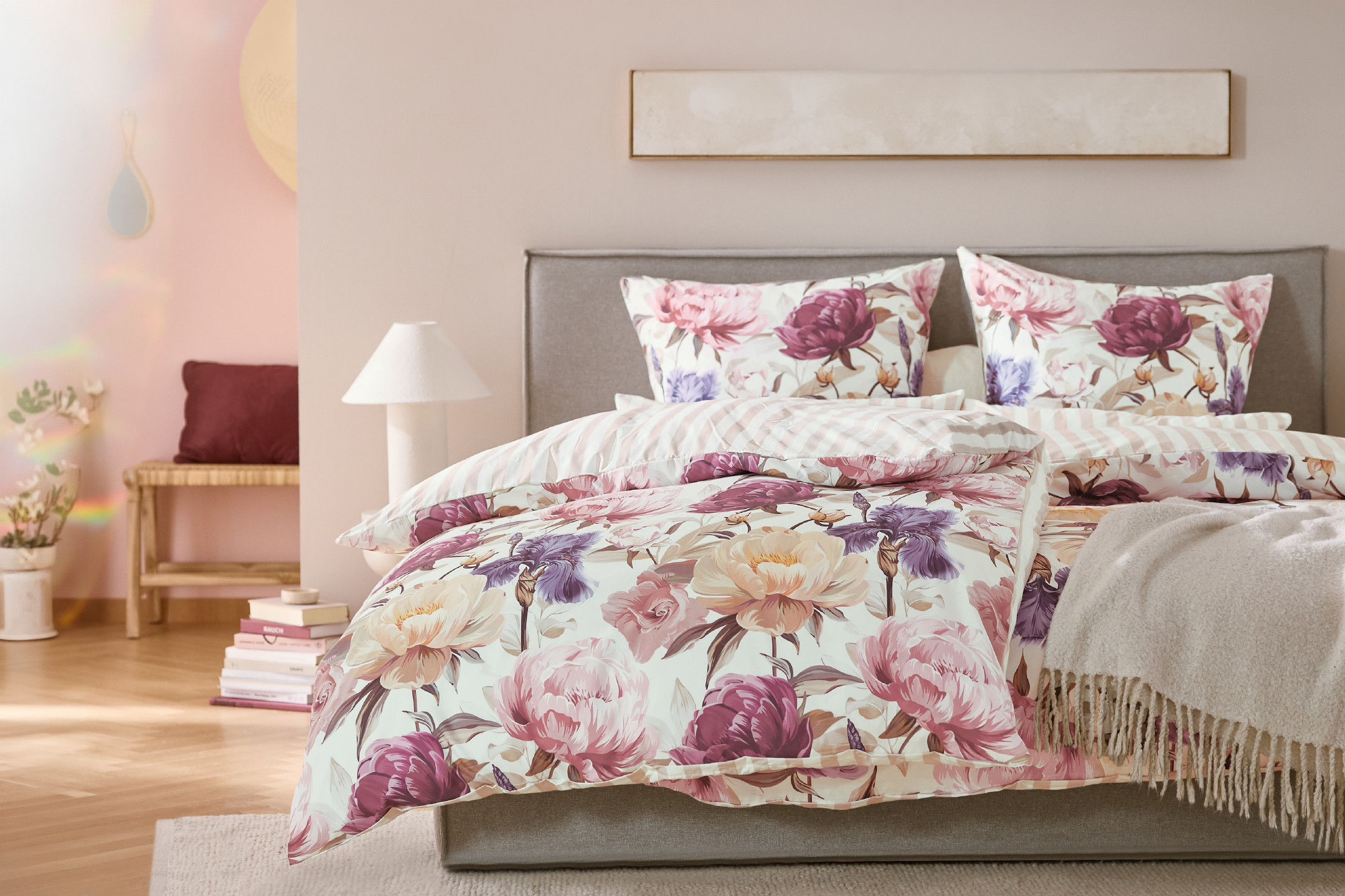 Floral patterned bedding set on a bed in a cozy bedroom setting.