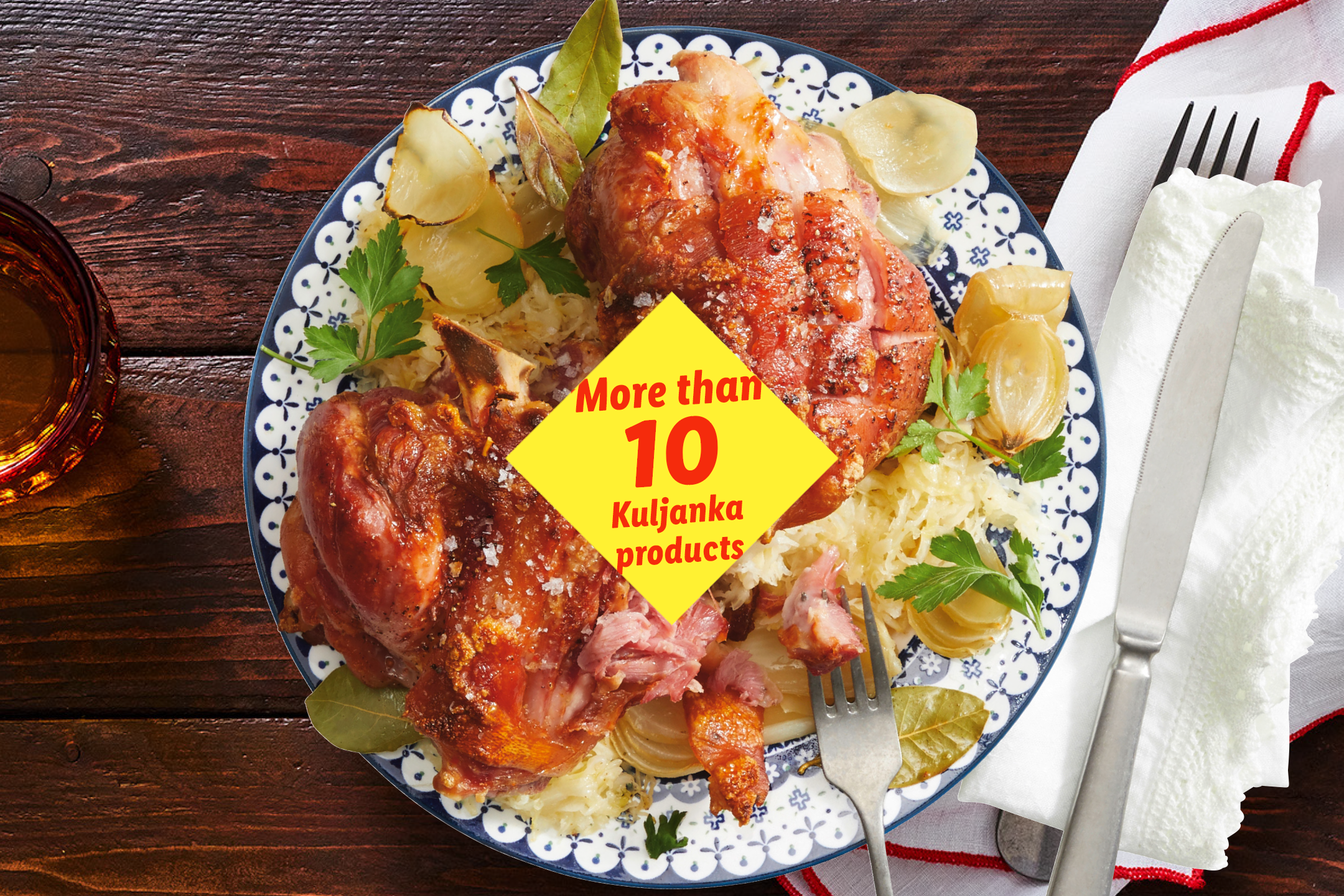 Roasted pork knuckle with sauerkraut and onions, with a text overlay: 'More than 10 Kuljanka products'