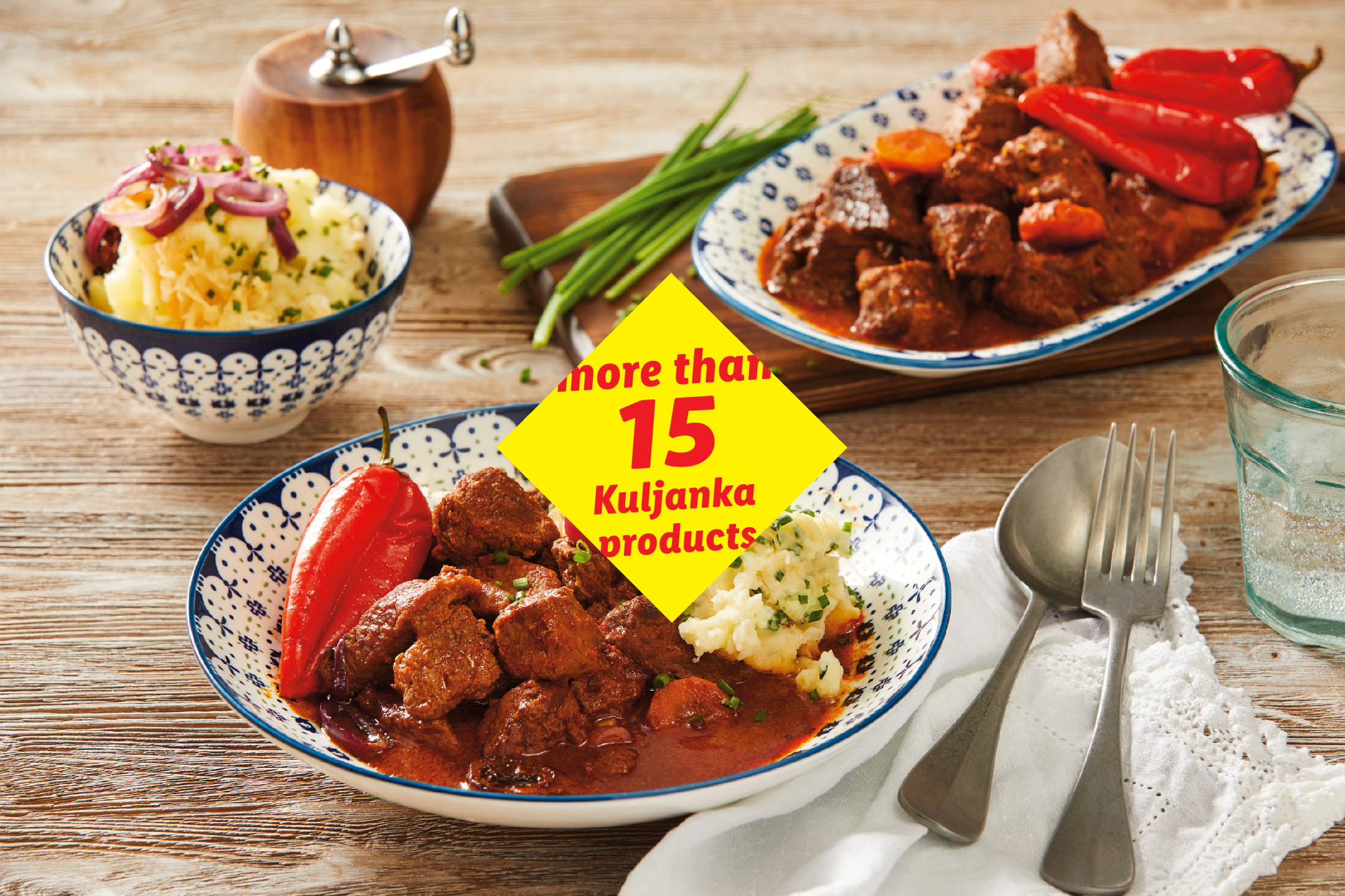 Two plates of goulash with mashed potatoes and red peppers, with a text overlay.