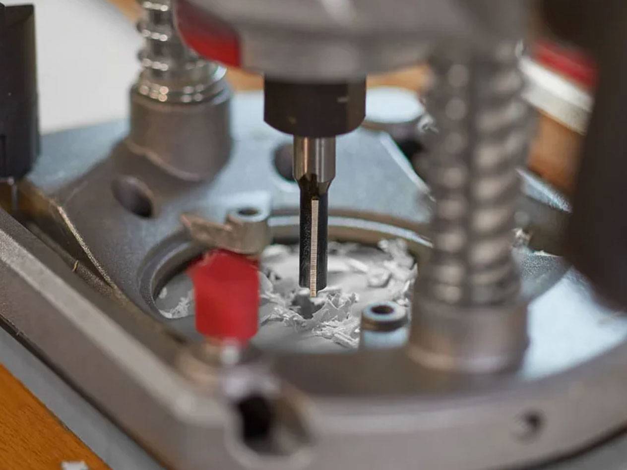 Router and cutting bit in use.